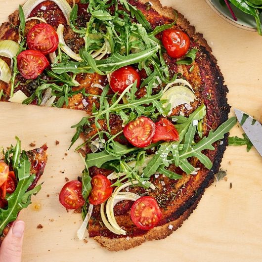 Artgerechte Pizza mit Rucola, Tomaten & Salat